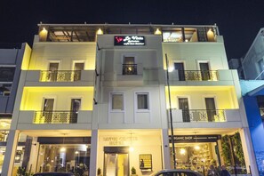 A multi-story building with a sign for 'La Vista' and 'Lotus Center Hotel' on the ground floor. - Lotus Center Apartments (Athens)
