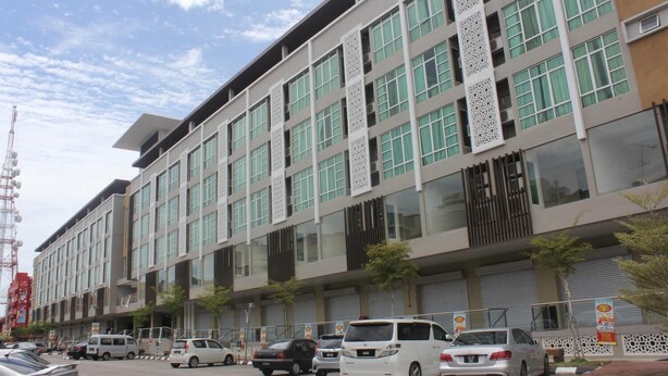 A modern multi-story building with a flat facade, large windows, and decorative vertical elements. - AL-Aidid Homestay (Kota Bharu)