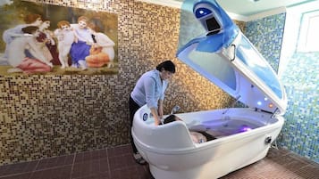 Relax in comfort with a soothing massage in this serene space, featuring a massage chair and a calming mosaic design.