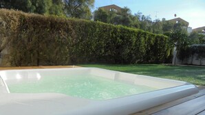 A rectangular hot tub with a wooden deck in front. - Lagos Charming Villas (Lagos)