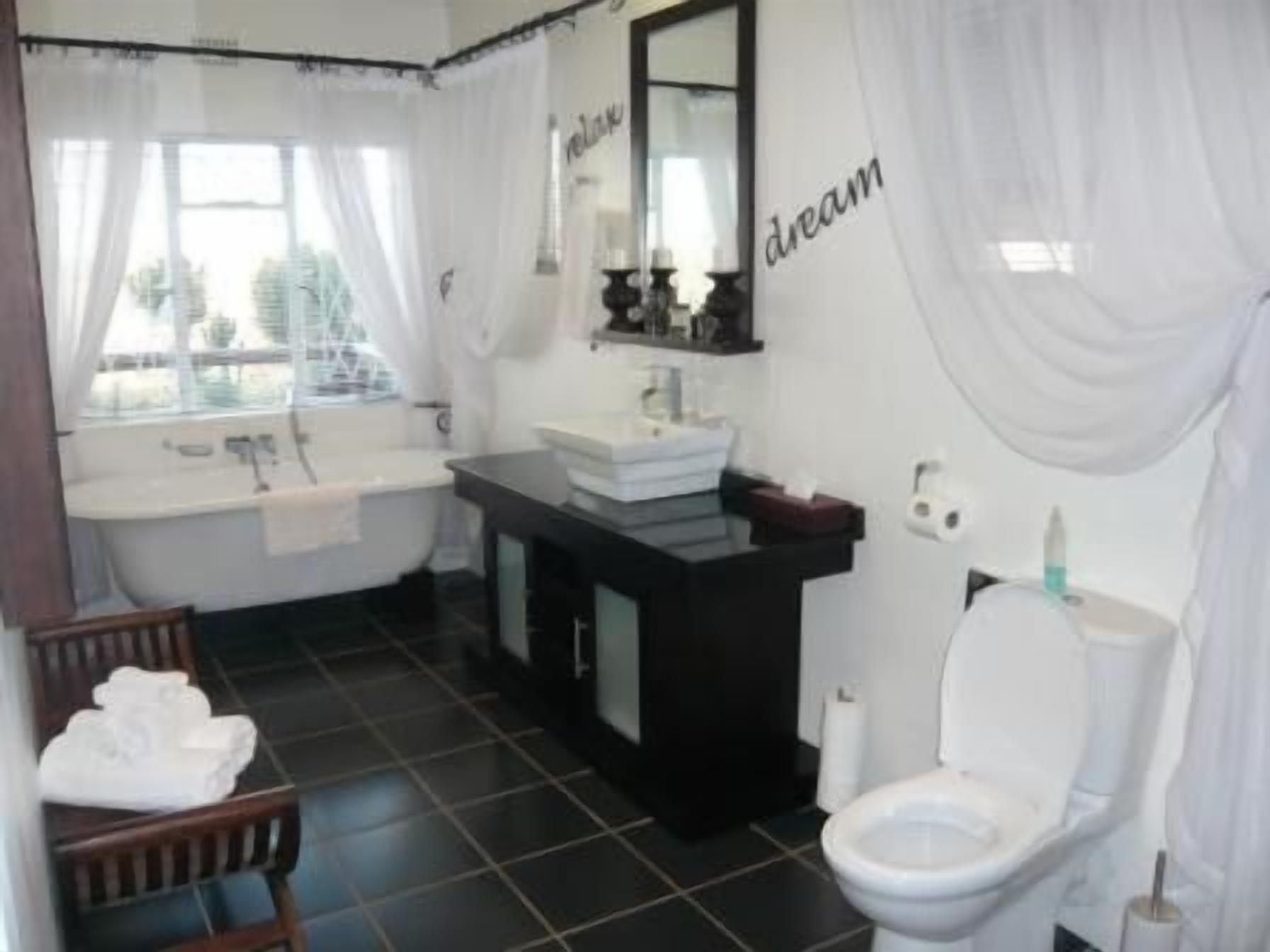 A bathroom with a bathtub, sink, and toilet.