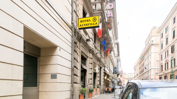 A hotel sign, a building facade, and a parked car. - Hotel Altavilla 9 (Rome)