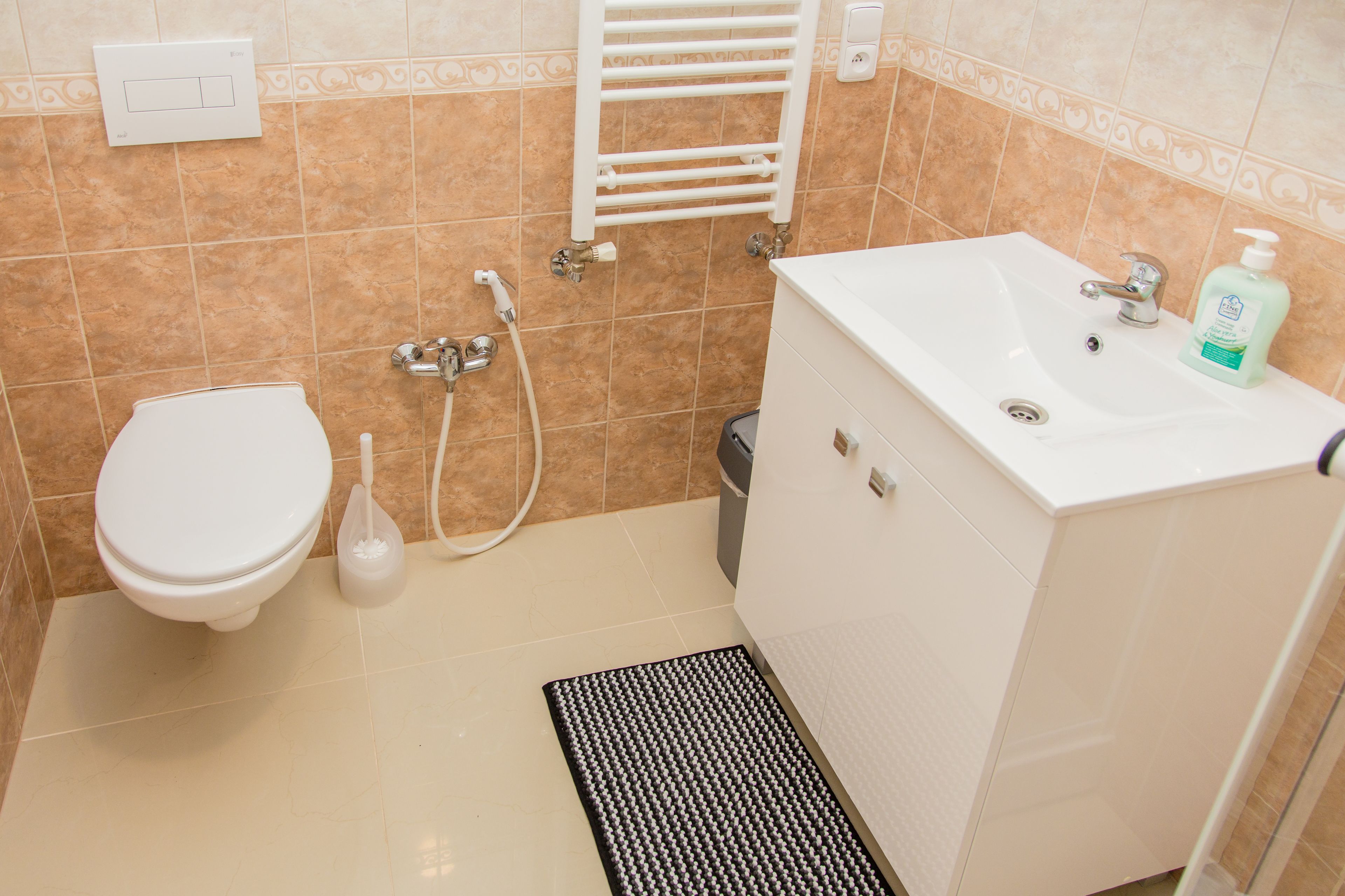 A bathroom with a toilet, sink, and shower.