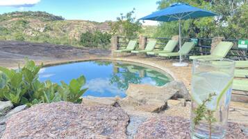 Una piscina al aire libre, tumbonas
