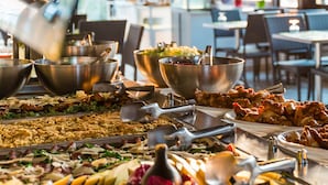 A buffet setup with various dishes and utensils. - Nicolaus Club Alimini Smile  (Otranto)