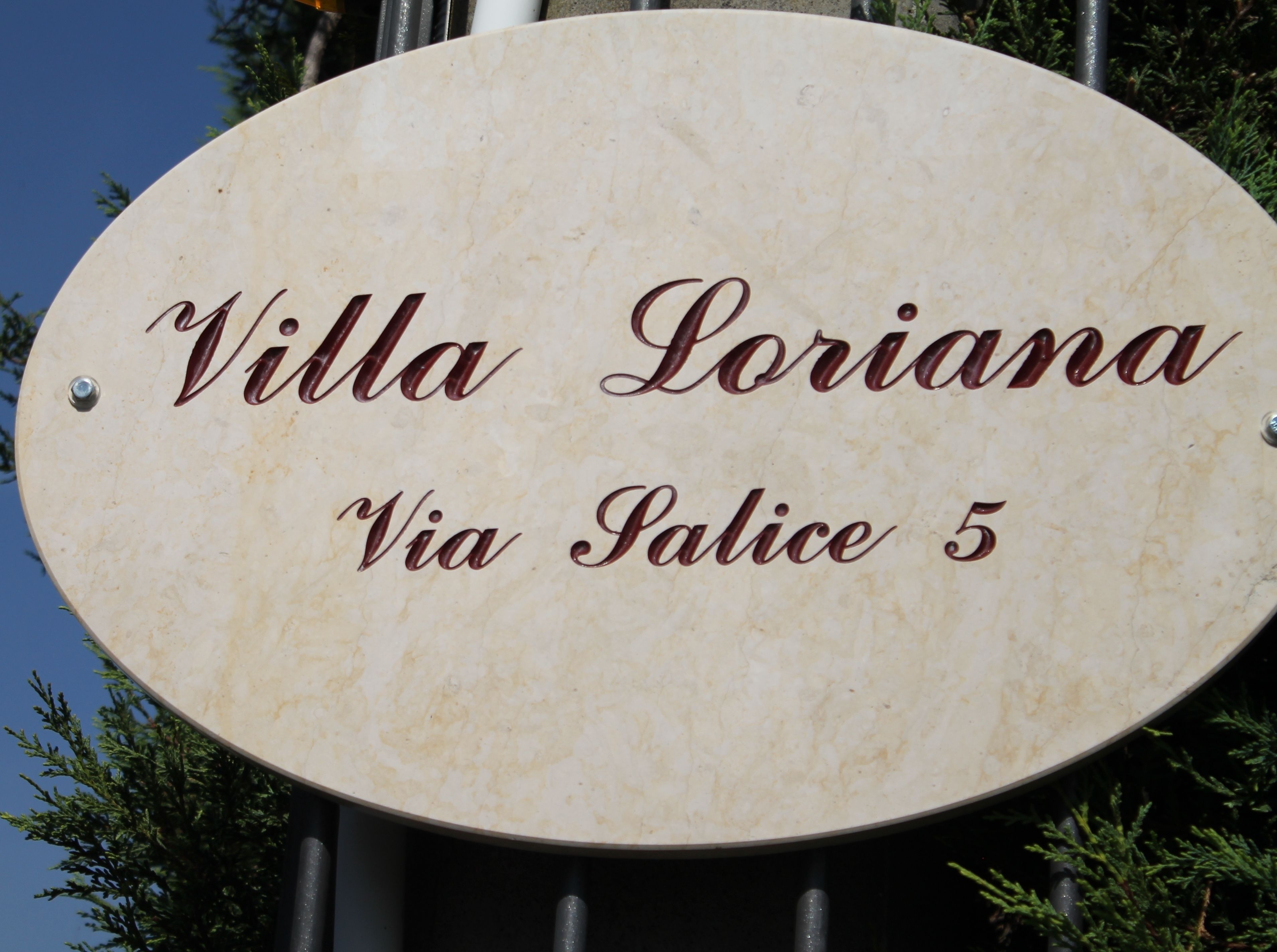 A sign for "Villa Loriani" with the address "Via Salice 5".