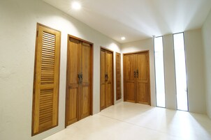 A hallway with wooden doors and a tiled floor.