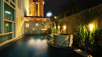 Outdoor pool, a waterfall pool, open 8:00 AM to 8:00 PM, pool umbrellas