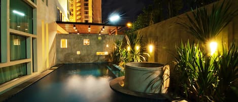 Outdoor pool, a waterfall pool, open 8:00 AM to 8:00 PM, pool umbrellas