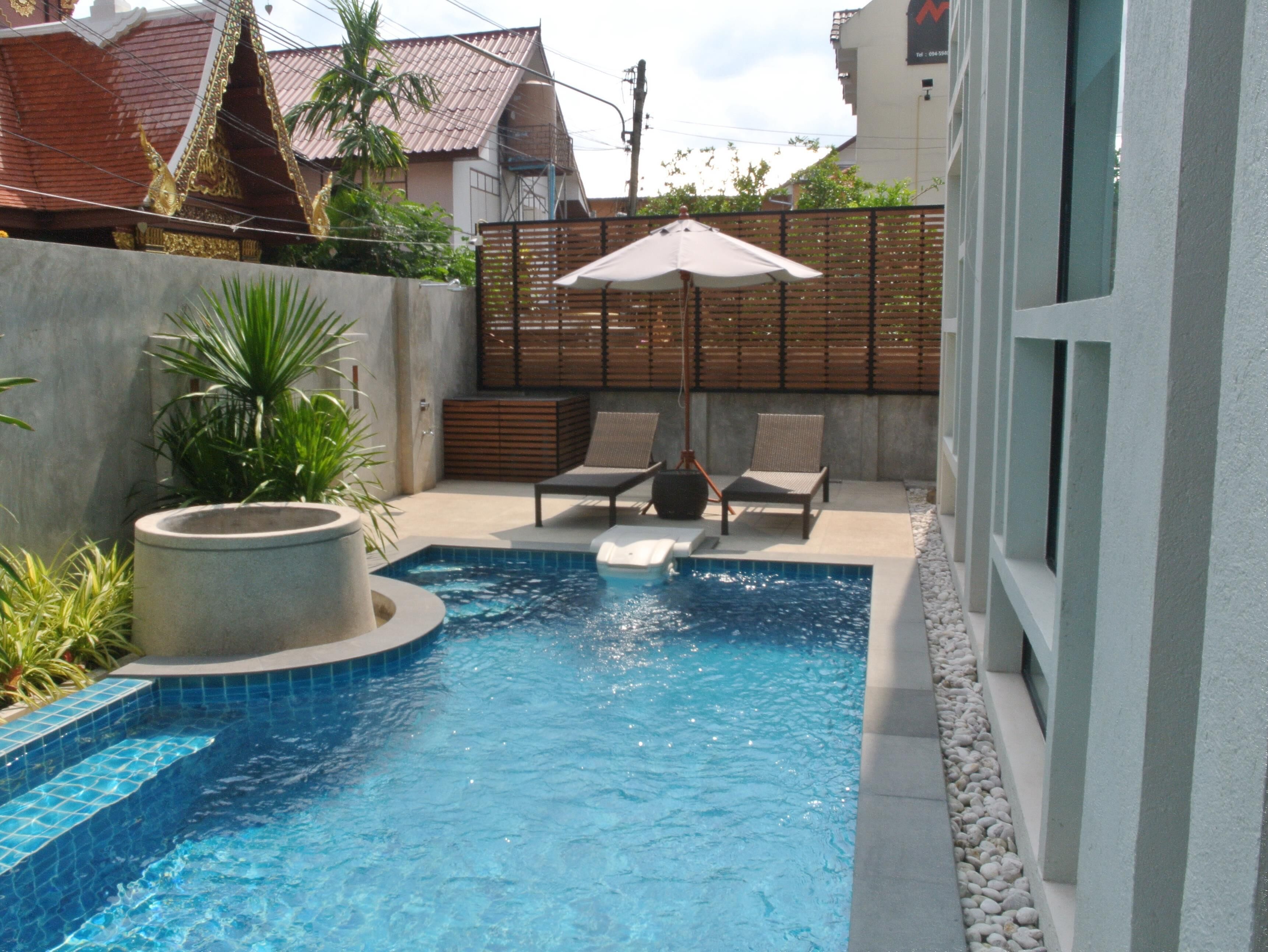 outdoor pool, a waterfall pool, open 8:00 am to 8:00 pm, pool umbrellas