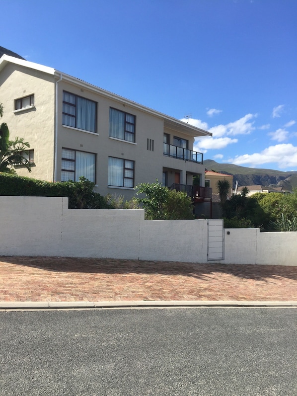 A modern two-story building with large windows and a balcony. - Hermanus Heights Villa (Hermanus)