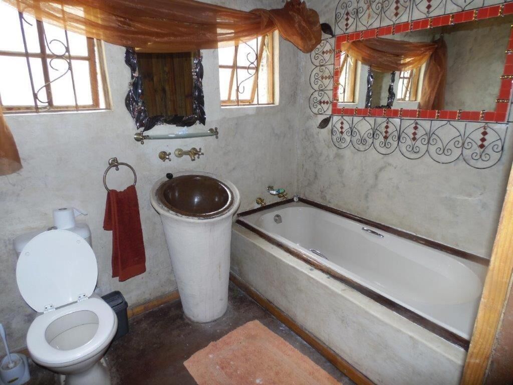 A bathroom with a toilet, sink, and bathtub.