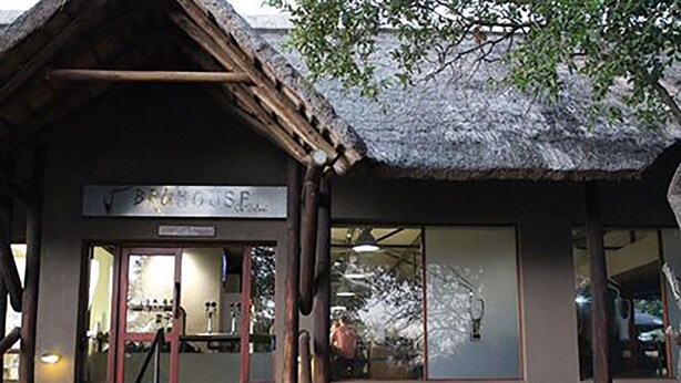 A building with a thatched roof and a sign reading "BRUGOSE". - Raptors Wildlife Escapes (Hoedspruit)