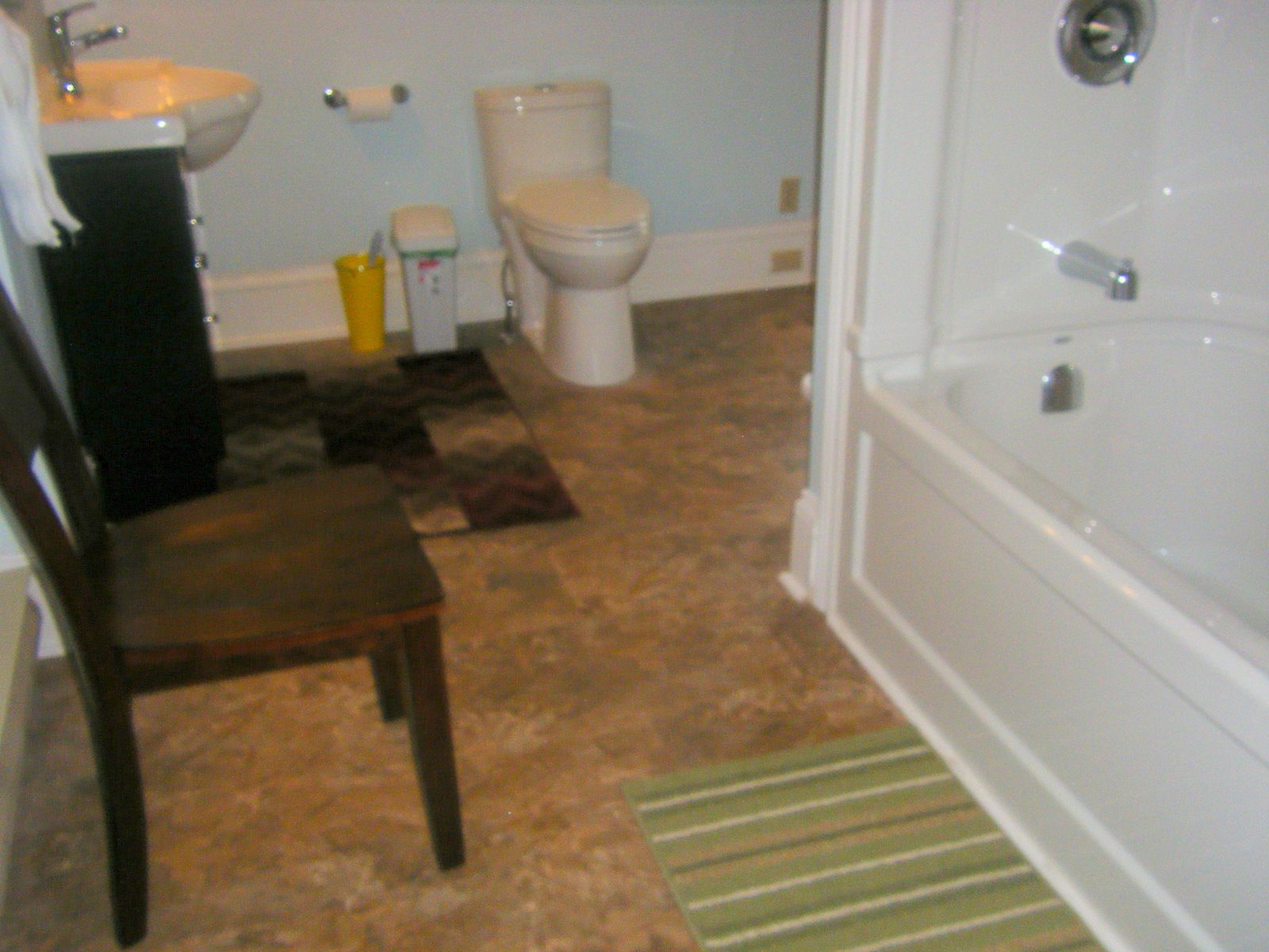 A bathroom with a toilet, sink, and bathtub.