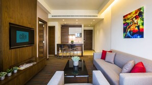 A modern hotel lobby with a flat-screen TV, a reception desk, a dining area, and a living room with a sofa and a coffee table. - Citea Apart-Hotel (Beirut)