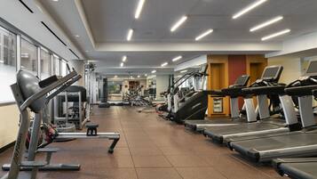 A gym with treadmills, ellipticals, and weight machines.