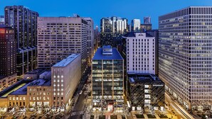 A high-rise building with a modern glass facade, surrounded by other tall buildings. - Residence Inn Chicago Downtown Magnificent Mile (Chicago)
