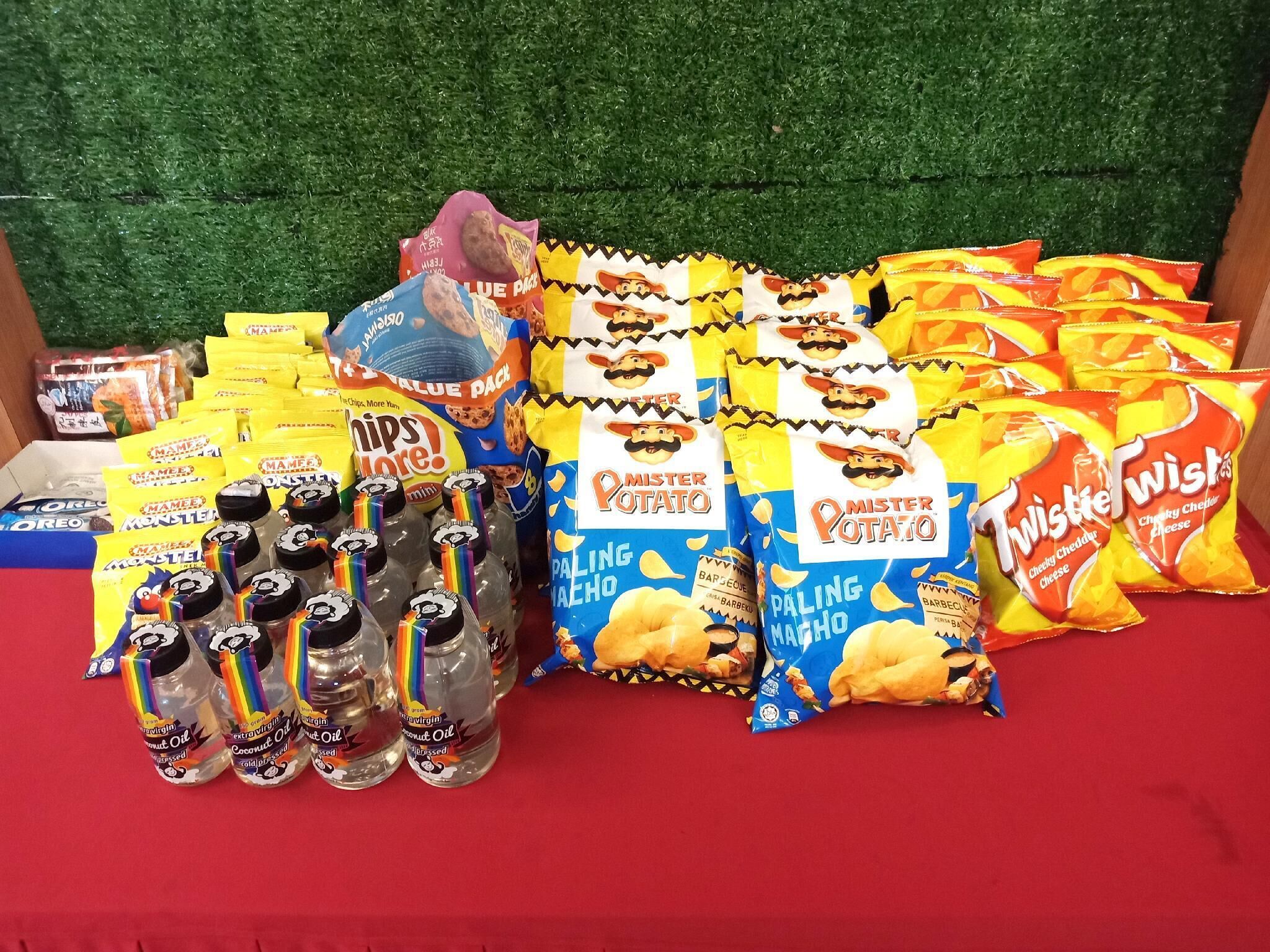 A variety of snack bags and bottles on a table.