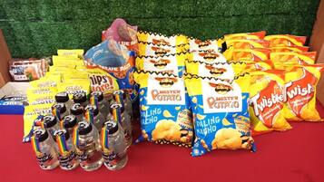 A variety of snack bags and bottles on a table.