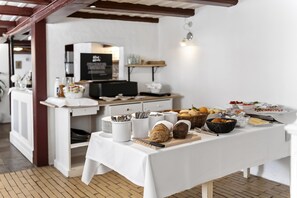 A buffet table with various food items, a coffee station, and a counter with a computer. - Brodremenighedens Hotel, BW Signature Collection (Christiansfeld)