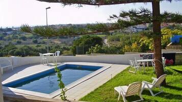 Seasonal outdoor pool, pool umbrellas, pool loungers