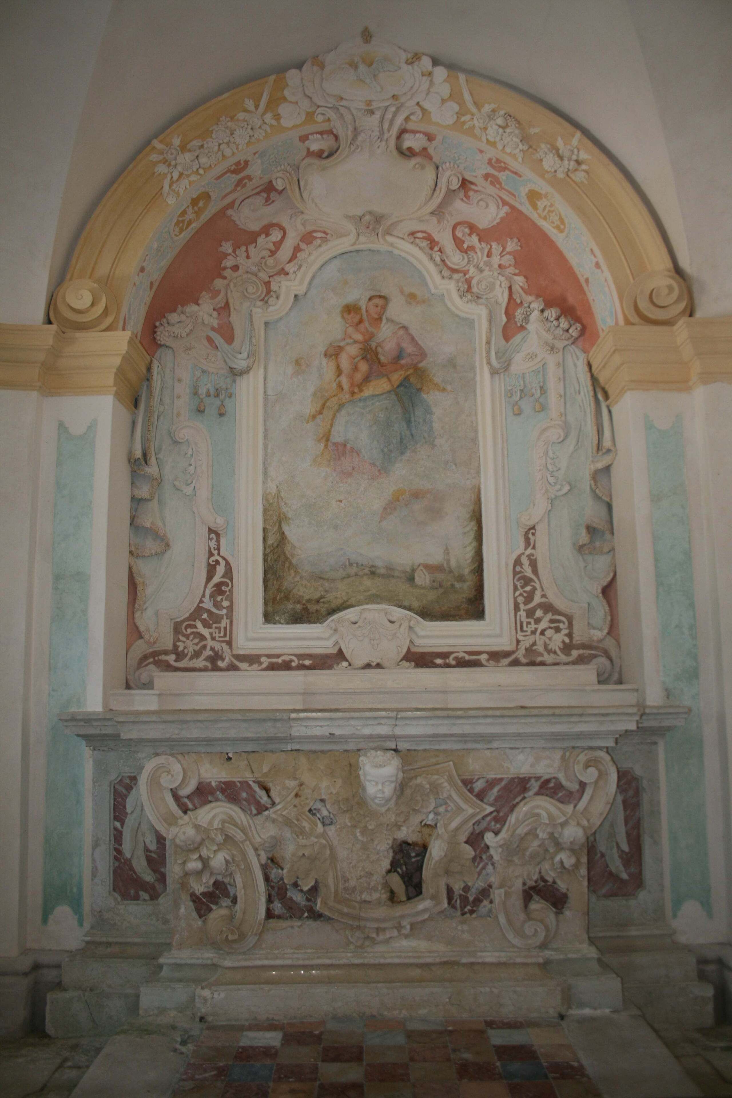 An ornate architectural detail with a fresco, a marble base, and a checkered floor.