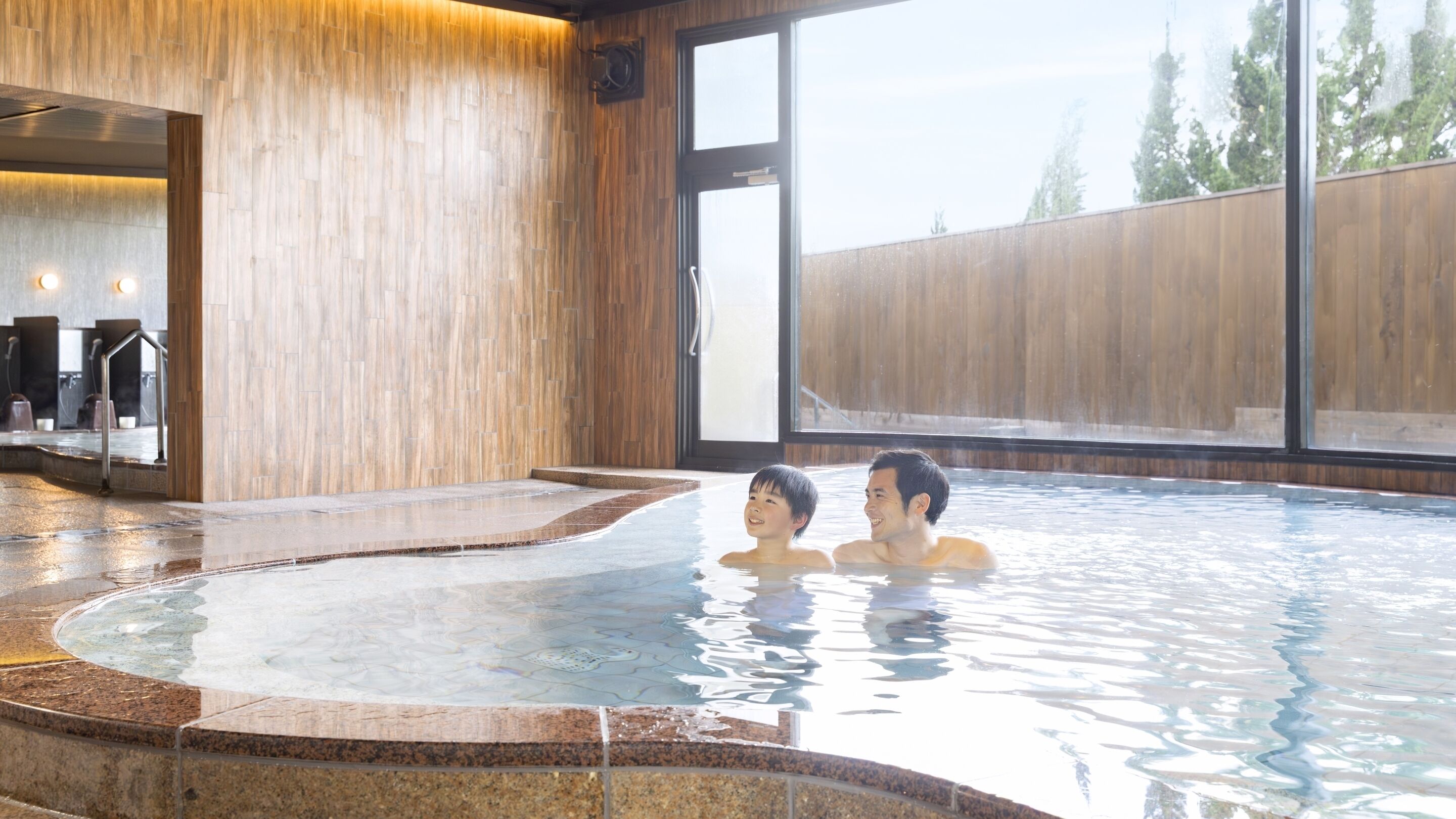 A hot spring area with a wooden wall and a large window.