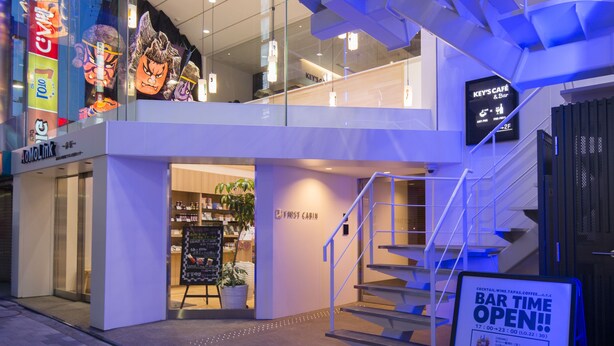 A modern building with a glass facade, a staircase, and a sign for 'KEY'S CAFE & Bar'. - First Cabin Akasaka (Tokyo)