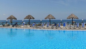 Outdoor pool, a rooftop pool, pool umbrellas, sun loungers