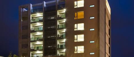 A multi-story hotel with illuminated signage at the top.