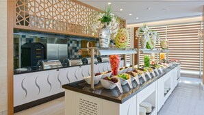 A buffet with various food items and decorative elements. - Asia Beach Resort & Spa Hotel (Alanya)