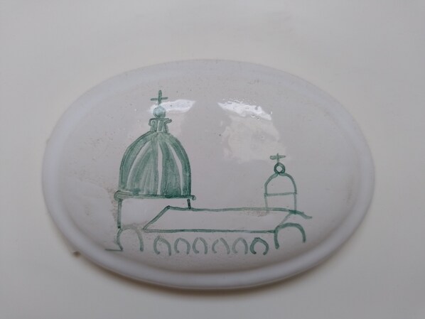 A simple drawing of a church with a dome and a bell tower.