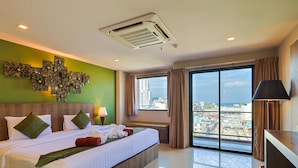 A hotel room with a large bed, a view of the city, and a modern design. - The Gig Hotel (Patong)