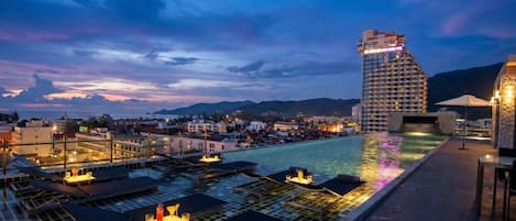 Una piscina al aire libre, sillones reclinables de piscina