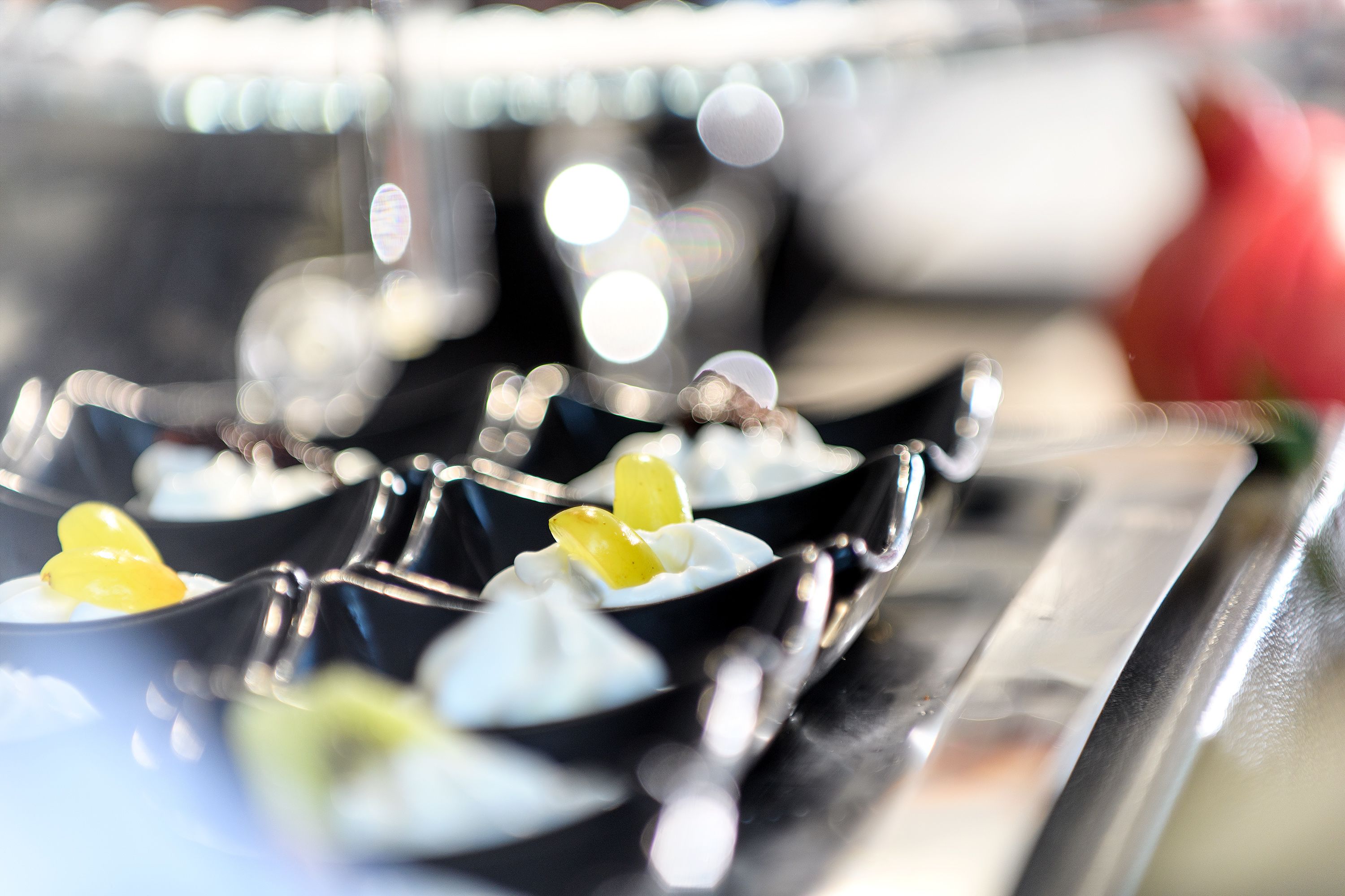 A close-up of a dessert presentation with a focus on the arrangement of dishes.