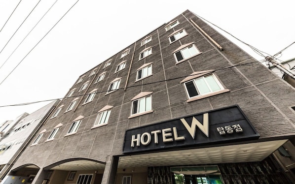 A multi-story hotel building with a prominent 'HOTEL W' sign.