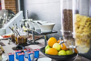 A buffet setup with various food items and utensils.