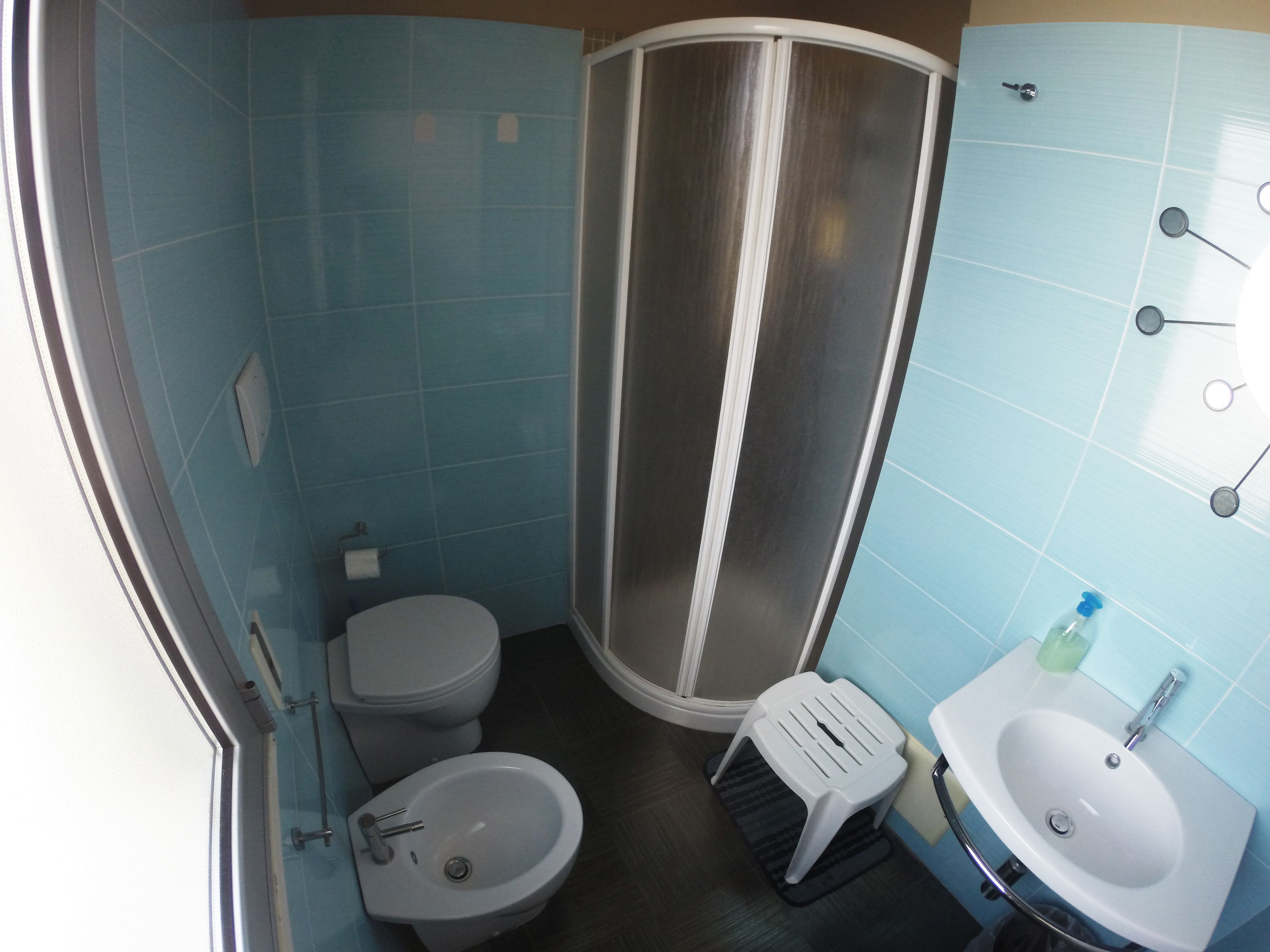 A small bathroom with a toilet, bidet, and sink.