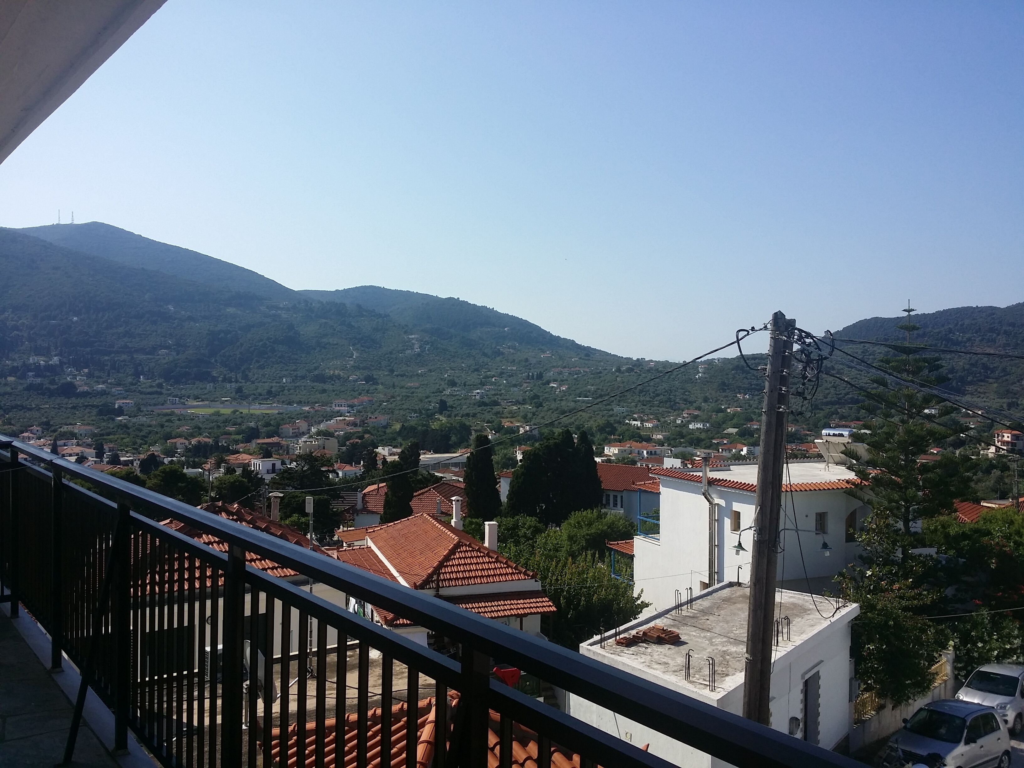 Un balcon avec vue sur la ville et les montagnes.