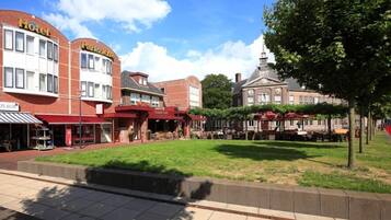 A hotel with a red facade and a sign that reads "Hotel".