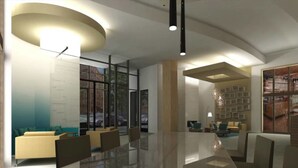 A modern interior with a curved ceiling, a glass wall with a city view, and a seating area with chairs and a table. - Bridgestreet the View at Liberty Center (Arlington)