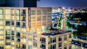A modern building with multiple floors, large windows, and balconies. - Bridgestreet the View at Liberty Center (Arlington)