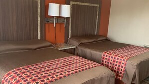 A hotel room with two beds, a nightstand, and two wall-mounted lamps.