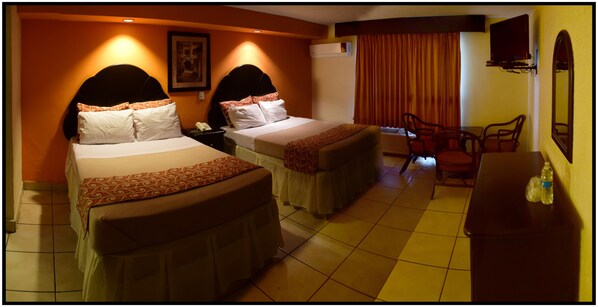 A hotel room with two beds, a desk, a chair, and a TV. - Hotel Yori (Cajeme)