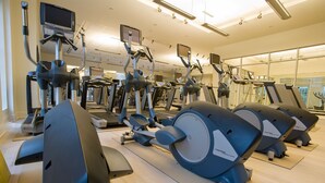 A gym with multiple exercise machines, including treadmills and stationary bikes, arranged in rows. - Griffin Hotel, an official Colonial Williamsburg Hotel (Williamsburg)