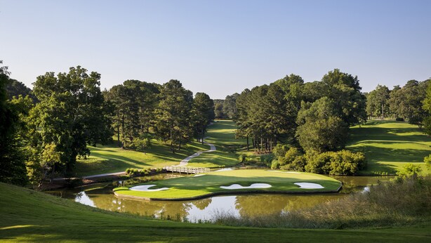 A golf course with a pond, trees, and a bridge. - Griffin Hotel, an official Colonial Williamsburg Hotel (Williamsburg)