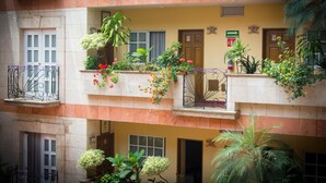 A multi-story building with balconies, some with plants and flowers. - Hotel Santa María (Mexico City)