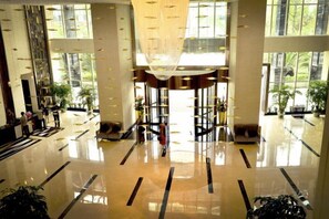 A spacious lobby with a high ceiling, large windows, and a central chandelier. - Mianyang Fulin Taohuadao Hotel (Mianyang)