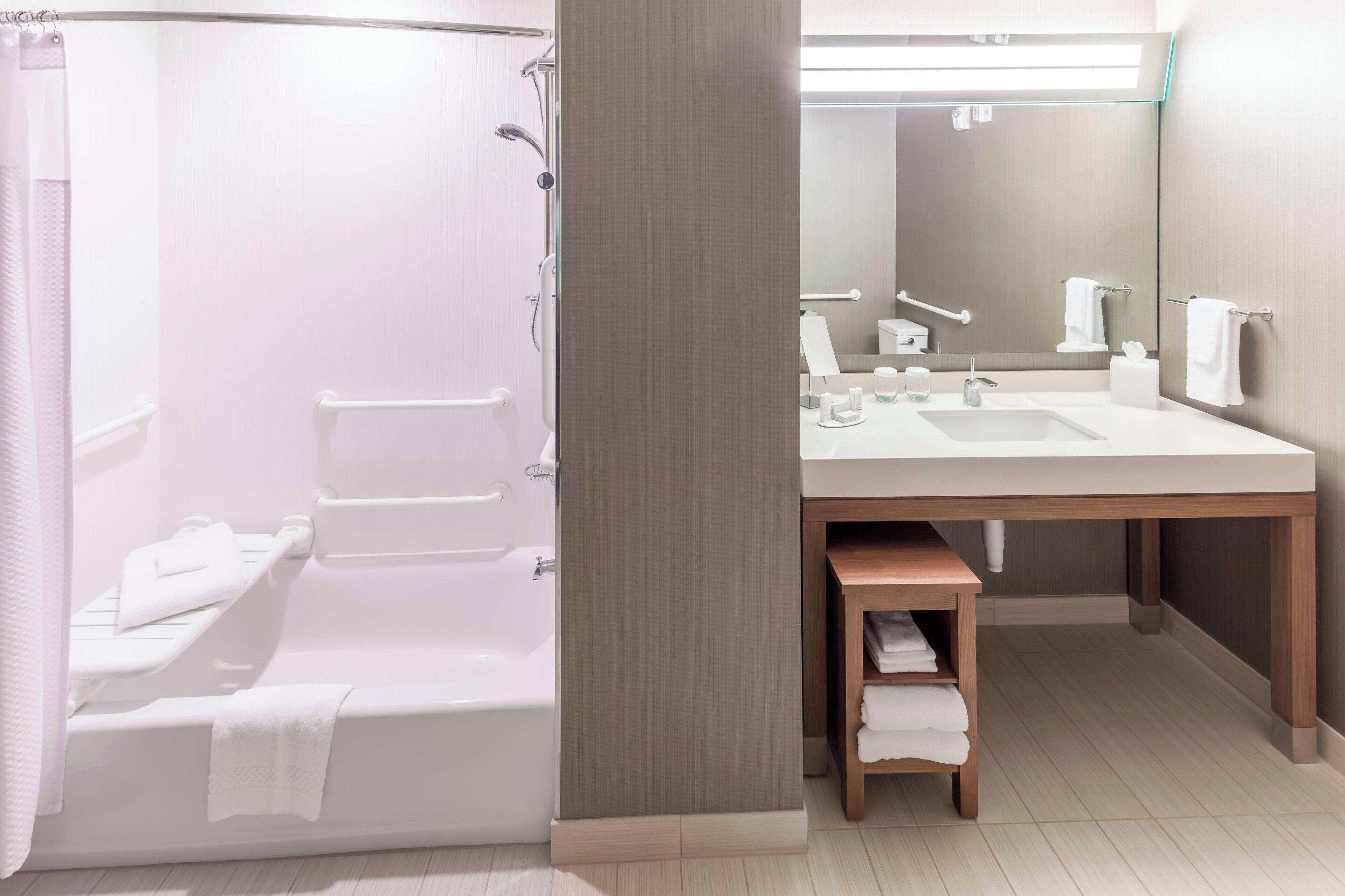 deep-soaking bathtub, rainfall showerhead, designer toiletries