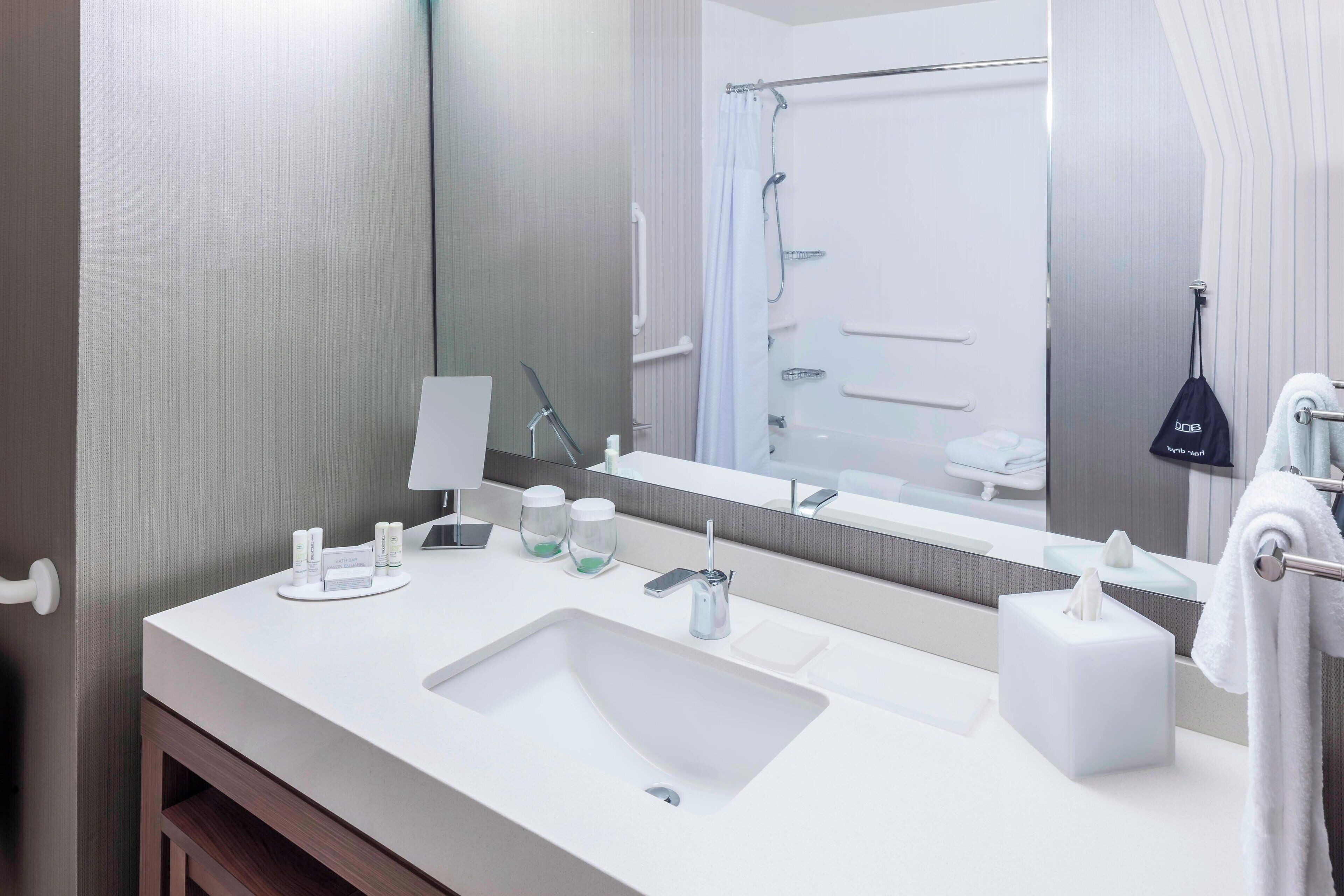 deep-soaking bathtub, rainfall showerhead, designer toiletries